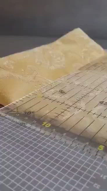 black rotary cutter cutting fabric
